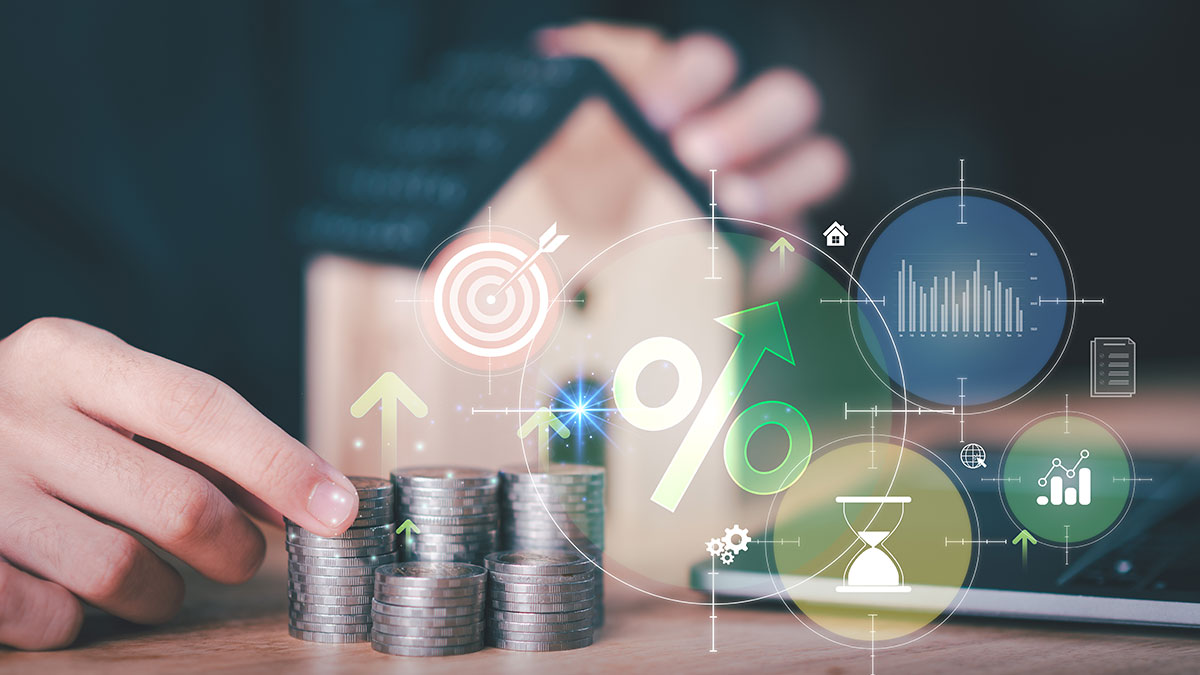 valuation model icons overlay over house model and real estate agent working on laptop